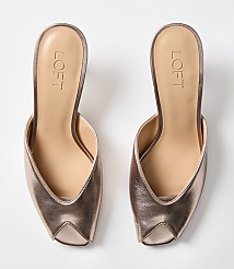 A pair of rose gold pointed-toe mules with the "LOFT" logo are displayed against a plain white background. carousel Product Image 3