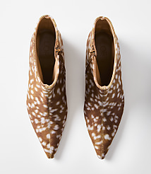 A pair of brown and white spotted ankle boots with pointed toes are displayed against a plain white background. carousel Product Image 3
