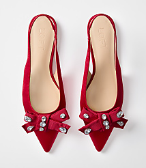 A pair of red satin slingback flats with jeweled bows are displayed against a plain white background. carousel Product Image 3