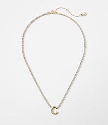 A delicate gold chain with a sparkling pendant in the shape of the letter "C" rests against a plain white background. carousel Product Image 1