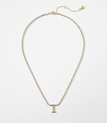 A delicate gold chain necklace with a sparkling "I" pendant rests on a plain white background. carousel Product Image 1