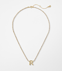 A gold letter "R" pendant on a delicate, sparkling chain rests against a plain white background. carousel Product Image 1