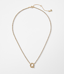 A delicate gold necklace with a sparkling "Q" pendant rests on a plain white background. carousel Product Image 1