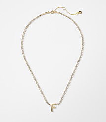 A gold letter "F" pendant hangs from a delicate, diamond-encrusted chain against a plain white background. carousel Product Image 1