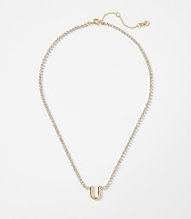 A gold letter "U" pendant hangs from a delicate, diamond-encrusted chain against a plain white background. carousel Product Image 1