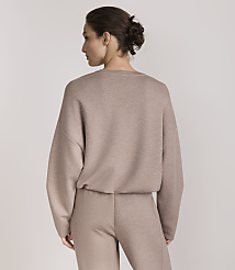 A woman in a taupe loungewear set stands against a plain, light gray background. carousel Product Image 3