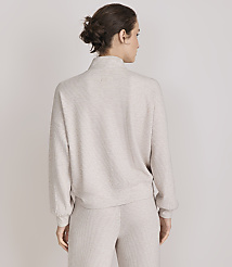 A woman in a beige mock-neck sweater and matching pants stands against a plain white background. carousel Product Image 3