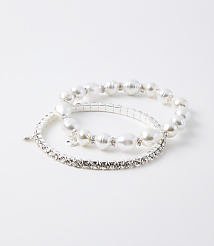 Two bracelets, one with pearls and rhinestones and another with only rhinestones, rest on a plain white background. carousel Product Image 1
