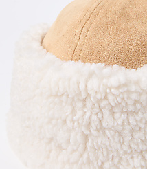 A close-up of a tan suede hat with a fluffy white trim is set against a plain white background. carousel Product Image 2