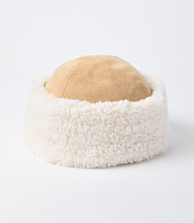 A tan suede hat with a fluffy white trim sits on a plain white background. carousel Product Image 1