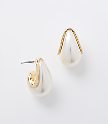 A pair of pearl and gold teardrop earrings rests on a plain white background. carousel Product Image 1