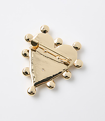 A gold heart-shaped brooch with decorative spheres around its edge is displayed against a plain white background. carousel Product Image 2