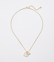 A delicate gold chain necklace with a heart-shaped pearl and a small gold heart charm hangs against a plain white background. carousel Product Image 1