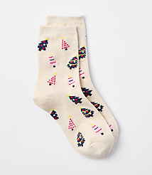 A pair of cream-colored socks with a pattern of festive Christmas trees are laid out against a plain white background. carousel Product Image 1
