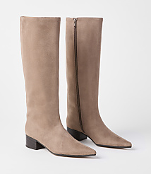A pair of taupe suede knee-high boots with pointed toes and block heels stand against a plain white background. carousel Product Image 1