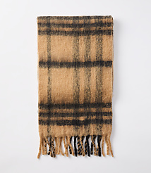 A fuzzy, plaid scarf with fringed ends lies flat against a plain white background. carousel Product Image 2