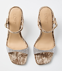 A pair of beige velvet sandals with rhinestone embellishments on the toe strap and ankle strap are displayed against a plain white background. carousel Product Image 3