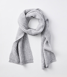 A light gray waffle-knit scarf is draped over a plain white background. carousel Product Image 1
