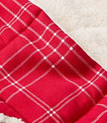A close-up of red and white plaid fabric in the foreground is set against a soft, textured cream background. carousel Product Image 2