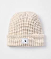 A cream-colored waffle-knit beanie with a small black ampersand logo on a white tag rests on a plain white background. carousel Product Image 1