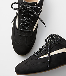 A pair of black suede sneakers with cream stripes and black and white laces rests on a plain white background. carousel Product Image 2