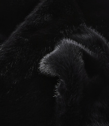 A close-up of black faux fur with soft folds in the foreground and a darker, less textured background. carousel Product Image 2