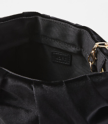 A black velvet clutch with a gold chain strap is shown against a plain white background. carousel Product Image 2