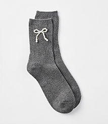 A pair of dark gray ribbed socks with a pearl bow detail rests on a plain white background. carousel Product Image 1