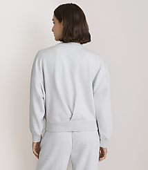 A woman in a grey sweatshirt and sweatpants stands against a plain white background. carousel Product Image 3
