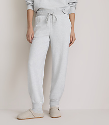 A person wearing light grey sweatpants and slippers stands against a plain, light grey background. carousel Product Image 2