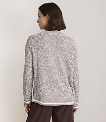 A woman in a speckled brown and white sweater stands against a plain, light brown background. carousel Product Image 3