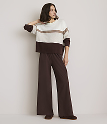 A woman in a striped sweater and wide-leg pants stands against a plain white background. carousel Product Image 2