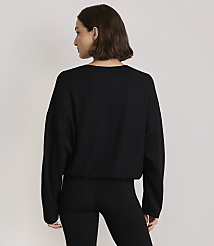 A woman in a black sweater and leggings stands against a plain, light-colored background. carousel Product Image 3