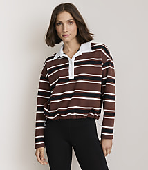 A woman in a striped collared shirt and black leggings stands against a plain, light-colored background. carousel Product Image 2