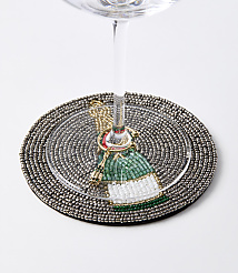 A beaded coaster with a festive bottle charm encircles the stem of a wine glass against a plain white background. carousel Product Image 2