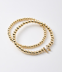 A gold beaded bracelet with a diamond-encrusted initial "H" rests on a plain white background. carousel Product Image 1