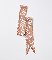 A rust-colored satin scarf with a white speckled pattern lies on a plain white background. carousel Product Image 2