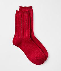 A pair of sparkly red ribbed socks rests on a plain white background. carousel Product Image 1