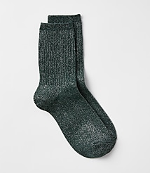 A pair of sparkly green crew socks rests on a plain white background. carousel Product Image 1