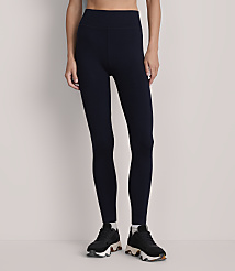 A person stands in dark blue leggings and black sneakers against a plain, light gray background. carousel Product Image 2
