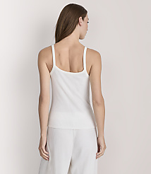 A woman in a white ribbed tank top and pants stands against a plain white background. carousel Product Image 3