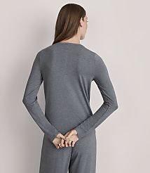 A woman in a grey long-sleeved shirt and pants stands with her back to the viewer against a plain grey background. carousel Product Image 3