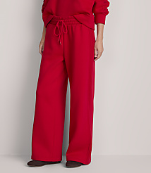 A person wearing bright red wide-leg sweatpants and dark shoes stands against a plain, light gray background. carousel Product Image 2
