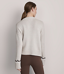 A woman in a light-colored sweater and brown leggings stands against a plain gray background. carousel Product Image 3