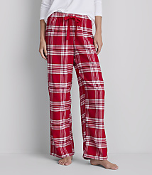 A person stands wearing red and white plaid pajama pants with a white top against a plain gray background. carousel Product Image 2