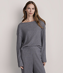 A woman in a grey ribbed sweater and pants stands against a plain grey background. carousel Product Image 2