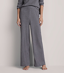 A person stands in ribbed gray wide-leg pants and a matching top against a plain gray background. carousel Product Image 2