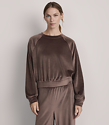 A woman in a brown velvet sweatshirt and matching pants stands against a plain, light gray background. carousel Product Image 1