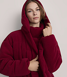 A woman in a red hooded jacket stands against a plain gray background. carousel Product Image 4