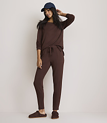 A woman in a brown loungewear set and a blue baseball cap stands against a plain white background. carousel Product Image 1